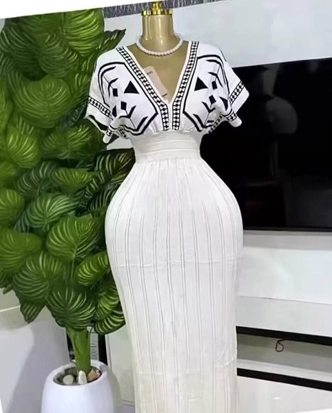 knitted V-neck dress features a white colorway and distinct black geometric pattern printing 2