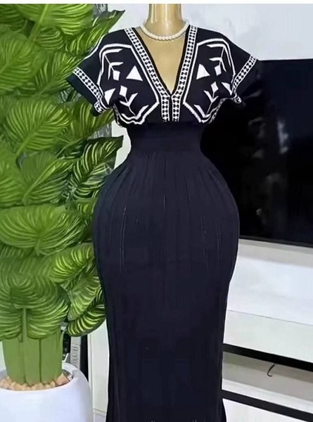 knitted V-neck dress features a white colorway and distinct black geometric pattern printing