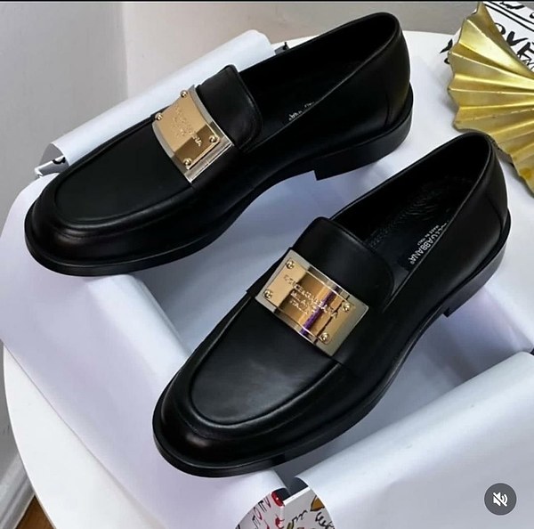 Leather Dolce & Gabbana dress loafers feature a prominent metallic brand plaque across the vamp