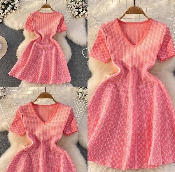 This pink knit dress features a V-neck and a fitted waist leading into a flare skirt.